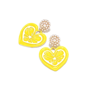 Detailed macro view of yellow enamel heart earrings with lemon slice pattern and pearls