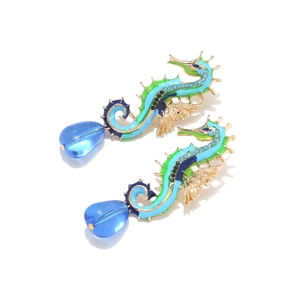Detailed view of colorful seahorse earrings with crystal accents and blue bead drops
