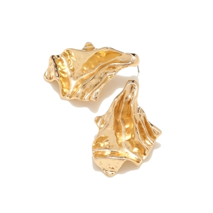 Detail of irregular golden stud earrings with modern hammered texture and geometric design