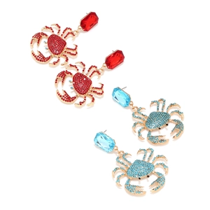 Detailed macro view of crab earrings with vibrant colorful rhinestones and gold alloy