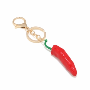 Creative 3D red chili pepper pendant keychain with golden clasp on white background