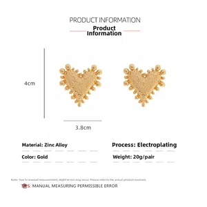 Detail of vintage gold heart stud earrings featuring beaded texture and size measurements