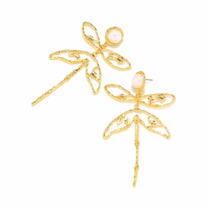 Detailed close-up of dragonfly earrings with golden hollow wings and pearl accents