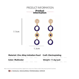 Detail view showing dimensions of long drop earrings with blue enamel and faux pearls
