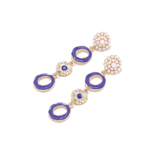 Detailed shot of long drop earrings with white pearls and blue enamel geometric charms