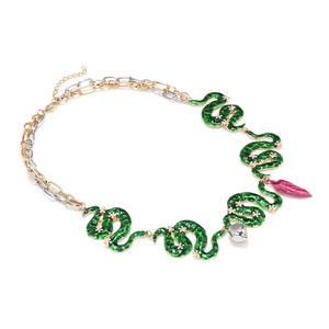 Detailed view of green enamel snake and flower necklace links with gold lobster clasp