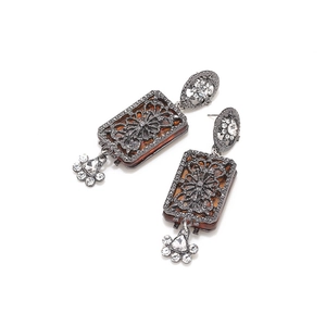 Detail of vintage palace style earrings with amber resin and crystal inlay