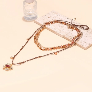 Bohemian multilayer necklace with beaded garnet crystals and gold hollow flower pendant