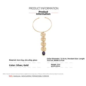 Detail of a vintage gold coin choker with a purple glass pendant and metal neck ring