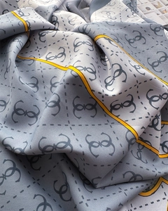 Close-up of elegant silk scarf with geometric patterns and luxurious satin texture
