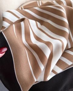 Detailed macro view of brown and white striped cotton linen shawl with herringbone weave