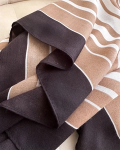 Detailed macro view showing the herringbone weave texture and striped pattern of the scarf