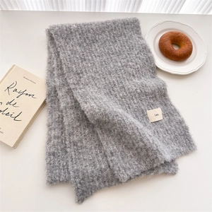 Detail of grey wool scarf texture with ins label and warm autumn lifestyle setting