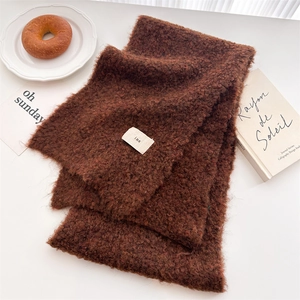Detail of brown teddy wool scarf texture with ins woven label and aesthetic decor