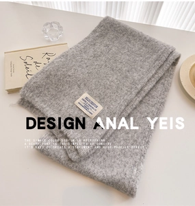 Detailed macro view of gray knitted wool scarf texture and woven brand label
