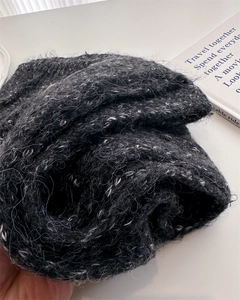 Detailed macro view of the fluffy black and white jacquard wool knit scarf texture