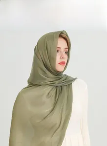 Detail of light green cotton linen scarf showing breathable texture and plain weave fabric