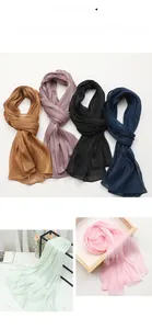 Close-up of lightweight chiffon silk scarves in multiple solid colors with fine rolled edges