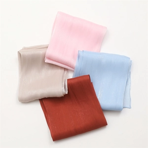 Elegant solid color satin scarves in four colors with silky texture and fine rolled edges