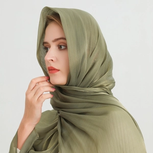 Close-up of olive green scarf showing delicate vertical pleated texture and silky sheen