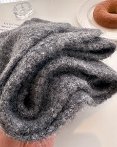 Close-up of thick dark grey wool knit scarf with soft mohair texture for winter