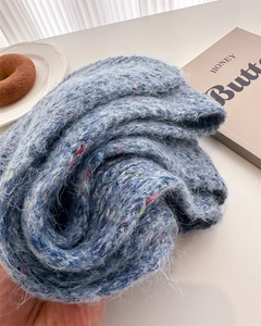 Detail of blue mohair knit scarf with multicolored speckles for winter warmth