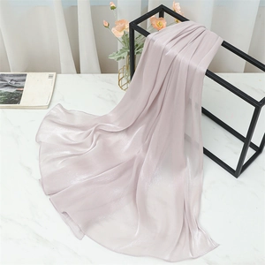 Close-up of soft light purple silk scarf with fine rolled edges on marble surface