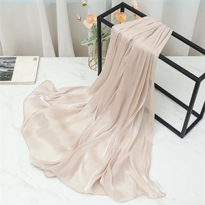 Detail view of champagne pleated silk scarf with soft pearlescent shimmer finish
