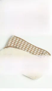 Close-up of houndstooth knit neck warmer with thick soft plush fleece lining