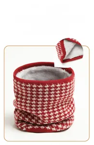 Close-up of red and white houndstooth knit scarf with warm grey plush lining detail