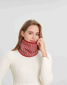 Detail of red and white houndstooth knit neck warmer in soft thickened wool texture