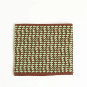 Detailed knit texture of houndstooth neck warmer in brown and mint green yarn