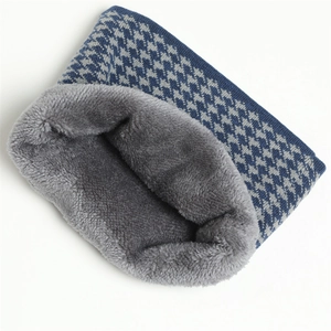 Detail of winter houndstooth knit neck warmer with thick grey plush fleece lining