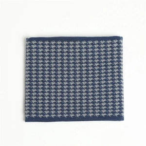 Detailed knit texture of houndstooth winter neck warmer in blue and grey tones