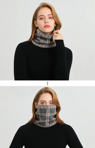 Detail of grey and beige knit neck gaiter with geometric pattern on warm fabric