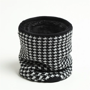 Detail of knit houndstooth neck warmer with thick black fleece lining for winter warmth