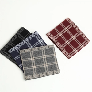 Detail of winter knitted neck gaiters featuring classic plaid patterns in various colors