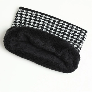 Detail of winter houndstooth neck warmer with thick black plush lining and knit texture