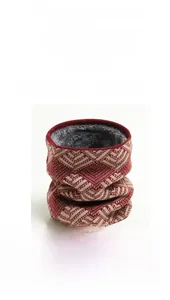 Detail of red geometric knit neck warmer with thick soft grey faux fur lining