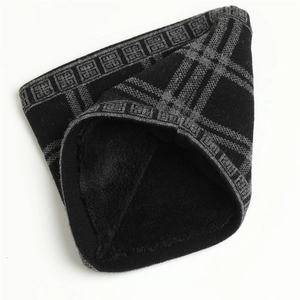 Close-up of knit neck warmer with plush fleece lining and grey geometric pattern