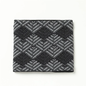 Close-up of black and grey geometric chevron knit pattern on winter neck warmer