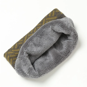 Close-up of winter knit neck warmer with thick gray faux rabbit fur lining and wavy pattern