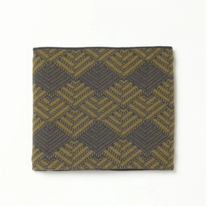 Detail of winter knitted neck warmer featuring olive green and grey geometric jacquard pattern
