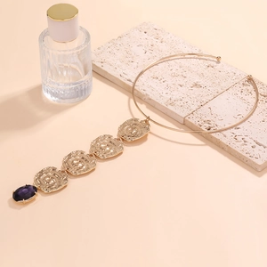 Statement gold necklace with hammered coin pendants and deep purple oval gemstone drop