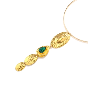 Vintage gold collar necklace with hammered oval pendants and a green gemstone drop