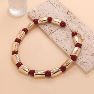 Close-up of geometric gold tube beads and burgundy beads necklace with lobster clasp