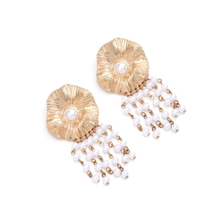 Golden flower earrings with radial texture and long dangling white pearl tassels