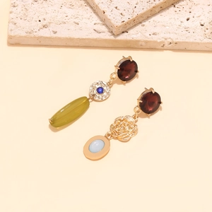 Detailed close-up of asymmetric alloy floral earrings with colorful crystals and gold resin