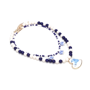 Multilayer beaded necklace with blue and white porcelain heart pendant and gold accents