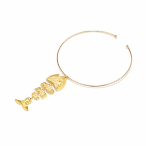 Golden choker necklace featuring a large tiered fish bone pendant with spiral engravings